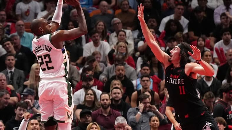 Nov 28, 2023; Miami, Florida, USA; Milwaukee Bucks forward Khris Middleton (22) shoots over Miami Heat guard Jaime Jaquez Jr. (11) during the first half at Kaseya Center. Mandatory Credit: Jasen Vinlove-USA TODAY Sports