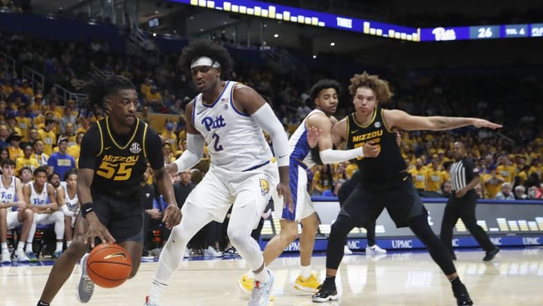 Nov 28, 2023; Pittsburgh, Pennsylvania, USA; Missouri Tigers guard Sean East II (55) drives the baseline against Pittsburgh Panthers forward Blake Hinson (2) during the first half at the Petersen Events Center. Mandatory Credit: Charles LeClaire-USA TODAY Sports