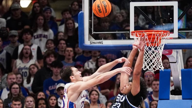 Nov 28, 2023; Lawrence, Kansas, USA; Kansas Jayhawks guard Nicolas Timberlake (25) shoots as Eastern Illinois Panthers forward Rodolfo Bolis (23) attempts to block during the first half at Allen Fieldhouse. Mandatory Credit: Denny Medley-USA TODAY Sports