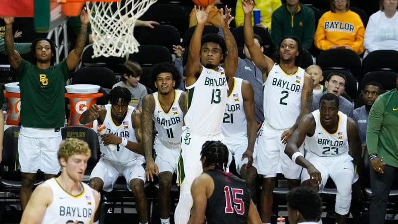 Nov 28, 2023; Waco, Texas, USA; Baylor Bears guard Langston Love (13) scores a three-point basket against Nicholls State Colonels forward Jamal West Jr. (15) during the second half at Ferrell Center. Mandatory Credit: Chris Jones-USA TODAY Sports