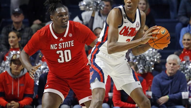Nov 28, 2023; Oxford, Mississippi, USA; Mississippi Rebels forward Jamarion Sharp (3) handles the ball as North Carolina State Wolfpack forward DJ Burns, Jr. (30) defends during the first half at The Sandy and John Black Pavilion at Ole Miss. Mandatory Credit: Petre Thomas-USA TODAY Sports