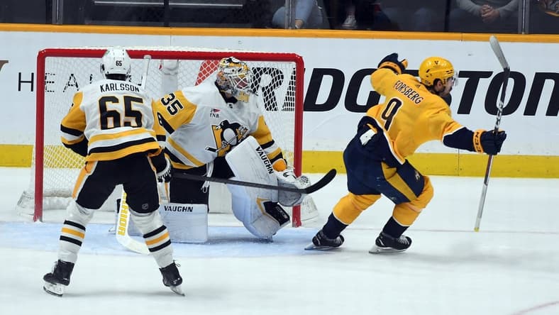 Nov 28, 2023; Nashville, Tennessee, USA; Nashville Predators left wing Filip Forsberg (9) scores the game-winning goal against Pittsburgh Penguins goaltender Tristan Jarry (35) in overtime at Bridgestone Arena. Mandatory Credit: Christopher Hanewinckel-USA TODAY Sports