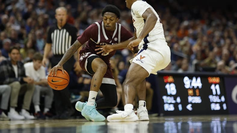 Nov 29, 2023; Charlottesville, Virginia, USA; Texas A&M Aggies guard Wade Taylor IV (4) dribbles the ball as Virginia Cavaliers guard Reece Beekman (2) defends in the first half at John Paul Jones Arena. Mandatory Credit: Geoff Burke-USA TODAY Sports