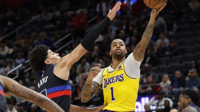 Nov 29, 2023; Detroit, Michigan, USA; Los Angeles Lakers guard D'Angelo Russell (1) shoots on Detroit Pistons guard Killian Hayes (7) in the first half at Little Caesars Arena. Mandatory Credit: Rick Osentoski-USA TODAY Sports