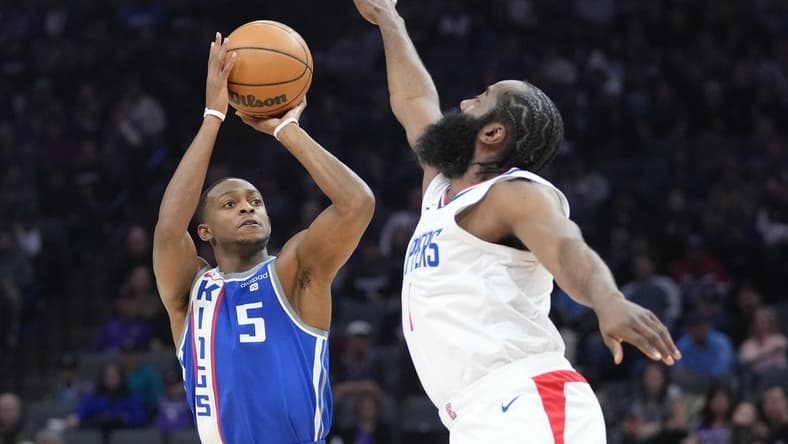 November 29, 2023; Sacramento, California, USA; Sacramento Kings guard De'Aaron Fox (5) shoots the basketball against LA Clippers guard James Harden (1) during the first quarter at Golden 1 Center. Mandatory Credit: Kyle Terada-USA TODAY Sports