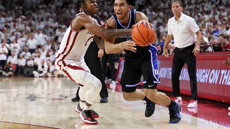 Nov 29, 2023; Fayetteville, Arkansas, USA; Duke Blue Devils guard Jared McCain (0) is fouled by Arkansas Razorbacks Khalif Battle (0) during the first half at Bud Walton Arena. Mandatory Credit: Nelson Chenault-USA TODAY Sports