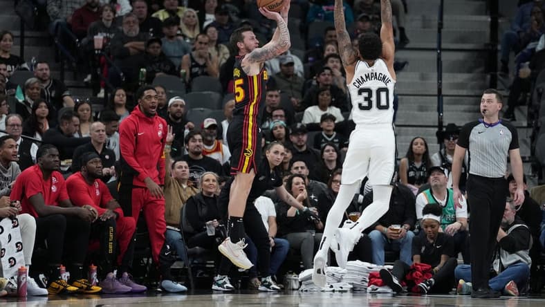 Nov 30, 2023; San Antonio, Texas, USA;  Atlanta Hawks guard Garrison Mathews (25) shoots over San Antonio Spurs forward Julian Champagnie (30) in the first half at the Frost Bank Center. Mandatory Credit: Daniel Dunn-USA TODAY Sports