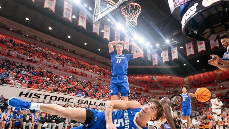 Nov 30, 2023; Stillwater, Oklahoma, USA; Oklahoma State Cowboys forward Eric Dailey Jr. (2) and Creighton Bluejays guard Francisco Farabello (5) dive after a loose ball during the first half at Gallagher-Iba Arena. Mandatory Credit: William Purnell-USA TODAY Sports