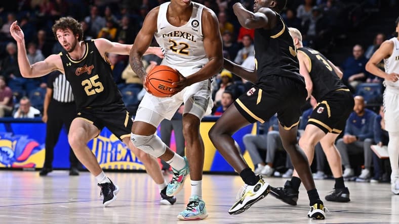 Feb 2, 2023; Philadelphia, Pennsylvania, USA; Drexel Dragons forward Amari Williams (22) drives against Charleston Cougars forward Babacar Faye (35) in the second half at Daskalakis Athletic Center. Mandatory Credit: Kyle Ross-USA TODAY Sports