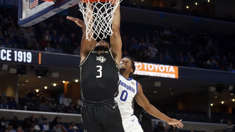 Feb 16, 2023; Memphis, Tennessee, USA; UCF Knights guard Darius Johnson (3) drives to the basket as Memphis Tigers guard Elijah McCadden (0) defends during the second half at FedExForum. Mandatory Credit: Petre Thomas-USA TODAY Sports