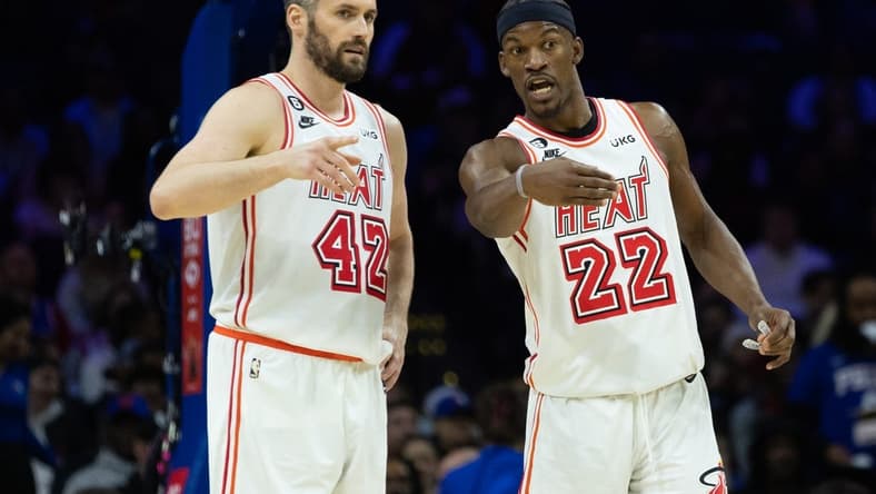 Feb 27, 2023; Philadelphia, Pennsylvania, USA; Miami Heat forward Jimmy Butler (22) talks with forward Kevin Love (42) during a break in action in the second quarter against the Philadelphia 76ers at Wells Fargo Center. Mandatory Credit: Bill Streicher-USA TODAY Sports