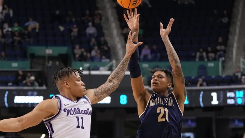 Mar 17, 2023; Greensboro, NC, USA; Montana State Bobcats guard RaeQuan Battle (21) shoots against Kansas State Wildcats forward Keyontae Johnson (11) in the second half at Greensboro Coliseum. Mandatory Credit: Bob Donnan-USA TODAY Sports