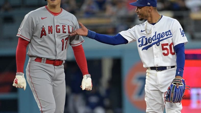 Jul 7, 2023; Los Angeles, California, USA; Los Angeles Angels starting pitcher Shohei Ohtani (17) and Los Angeles Dodgers right fielder Mookie Betts (50) talk while at second base during a play review in the fourth inning at Dodger Stadium. Mandatory Credit: Jayne Kamin-Oncea-USA TODAY Sports