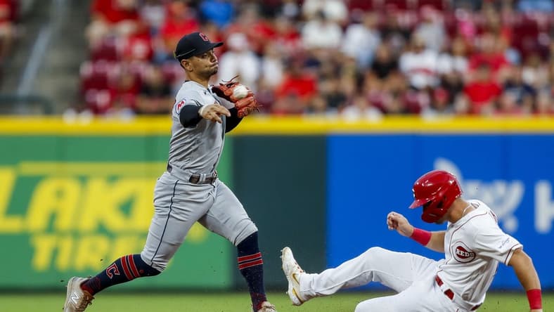 Aug 15, 2023; Cincinnati, Ohio, USA; Cleveland Guardians second baseman Andres Gimenez (0) forces out Cincinnati Reds centerfielder TJ Hopkins at second and throws to first to get Kevin Newman (not pictured) out to complete the double play in the fifth inning at Great American Ball Park. Mandatory Credit: Katie Stratman-USA TODAY Sports