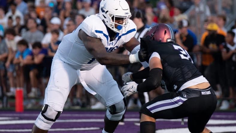 IMG's Jordan Seaton (77) holds off Lipscomb's Beck Woodside (35) at Lipscomb's Reese Smith Football Field in Nashville, Tenn., Friday night, Aug. 18, 2023.