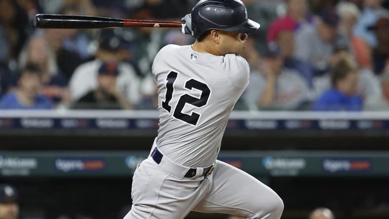 Aug 28, 2023; Detroit, Michigan, USA; New York Yankees center fielder Isiah Kiner-Falefa (12) hits a single in the eighth inning against the Detroit Tigers at Comerica Park. Mandatory Credit: Rick Osentoski-USA TODAY Sports