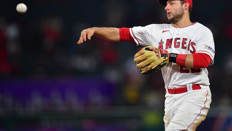 Sep 26, 2023; Anaheim, California, USA; Los Angeles Angels second baseman David Fletcher (22) throws to first for the out against Texas Rangers shortstop Josh Smith (47) during the seventh inning at Angel Stadium. Mandatory Credit: Gary A. Vasquez-USA TODAY Sports