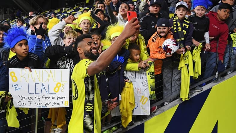 Oct 14, 2023; Nashville, Tennessee, USA; Nashville SC midfielder Anibal Godoy (20) celebrates with fans after the game against New England Revolution at Geodis Park. Mandatory Credit: Christopher Hanewinckel-USA TODAY Sports