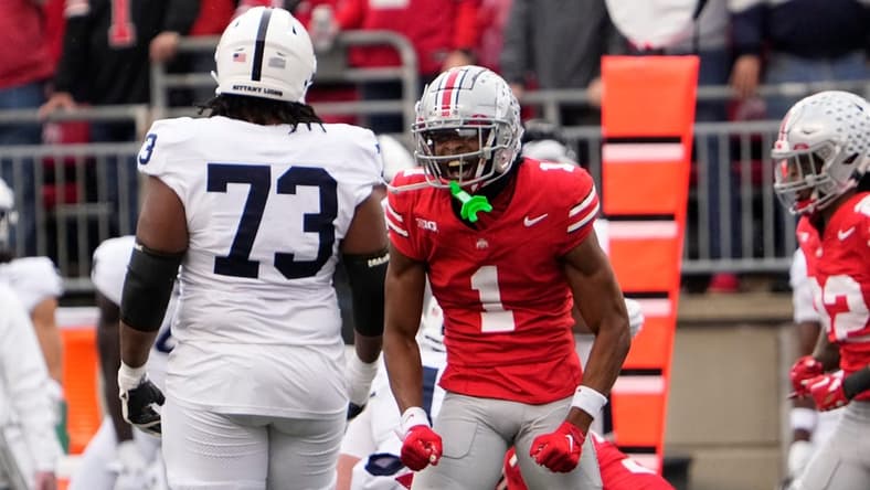 Oct 21, 2023; Columbus, Ohio, USA; Ohio State Buckeyes cornerback Davison Igbinosun (1) celebrates in front of Penn State Nittany Lions offensive lineman Caedan Wallace (73) during the NCAA football game at Ohio Stadium.