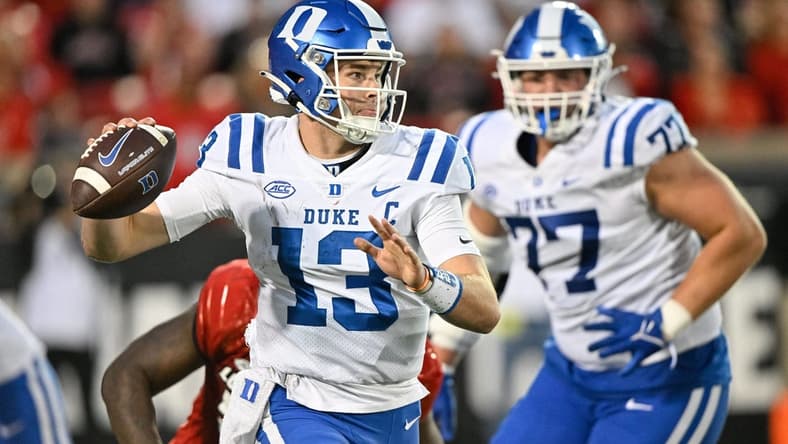 Oct 28, 2023; Louisville, Kentucky, USA; Duke Blue Devils quarterback Riley Leonard (13) looks to pass the ball against the Louisville Cardinals during the second half at L&N Federal Credit Union Stadium. Mandatory Credit: Jamie Rhodes-USA TODAY Sports