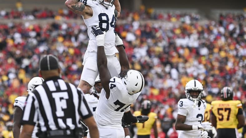 Nov 4, 2023; College Park, Maryland, USA; Penn State Nittany Lions offensive lineman Olumuyiwa Fashanu (74) celebrates with tight end Theo Johnson (84) after scoring a first half touchdown against the Maryland Terrapins at SECU Stadium. Mandatory Credit: Tommy Gilligan-USA TODAY Sports