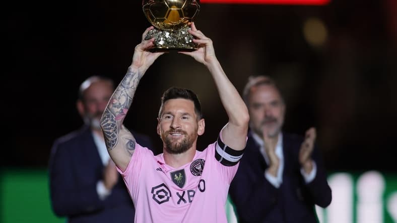 Nov 10, 2023; Lauderdale, FL, USA; Inter Miami forward Lionel Messi (10) poses with the Ballon d'Or trophy before the game against New York City at DRV PNK Stadium. Mandatory Credit: Sam Navarro-USA TODAY Sports