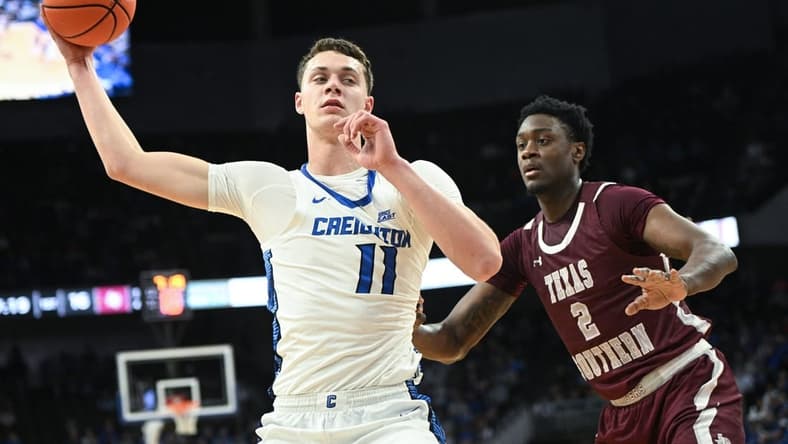 Nov 18, 2023; Omaha, Nebraska, USA; Creighton Bluejays center Ryan Kalkbrenner (11) looks to drive against Texas Southern Tigers forward Jahmar Young Jr. (2) in the first half at CHI Health Center Omaha. Mandatory Credit: Steven Branscombe-USA TODAY Sports