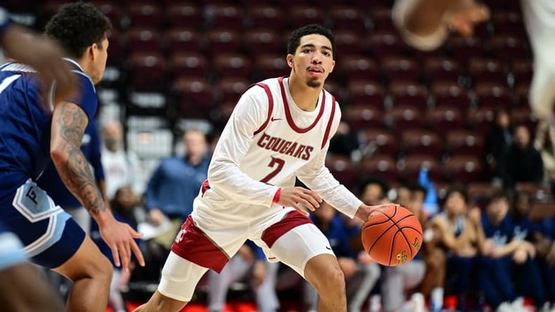 Nov 19, 2023; Uncasville, CT, USA; Washington State Cougars guard Myles Rice (2) dribbles the ball defended by Rhode Island Rams guard Luis Kortright (1) during the second half at Mohegan Sun Arena. Mandatory Credit: Mark Smith-USA TODAY Sports