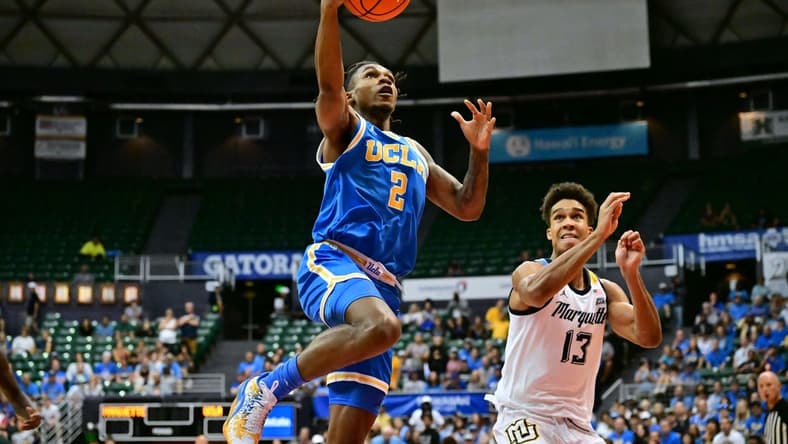 Nov 20, 2023; Honolulu, Hawaii, USA; UCLA Bruins guard Dylan Andrews (2) drives to the basket against Marquette Golden Eagles forward Oso Ighodaro (13) during the first period at SimpliFi Arena at Stan Sheriff Center. Mandatory Credit: Steven Erler-USA TODAY Sports