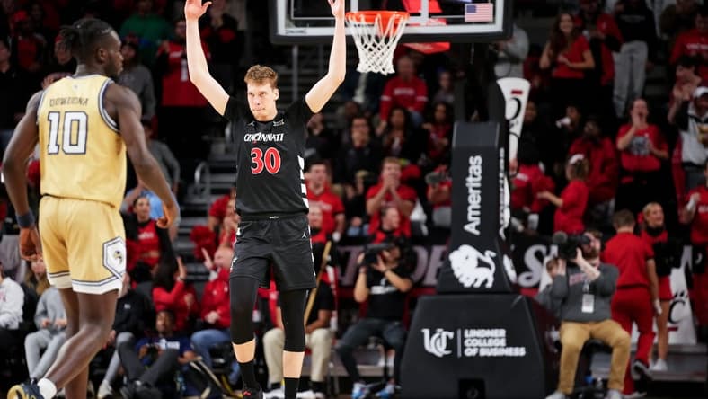 Cincinnati Bearcats forward Viktor Lakhin (30) encourages the crowd after a made 3-point basket in the second half during an NCAA college basketball game between Georgia Tech Yellow Jackets and the Cincinnati Bearcats, Wednesday, Nov. 22, 2023, at Fifth Third Arena in Cincinnati.