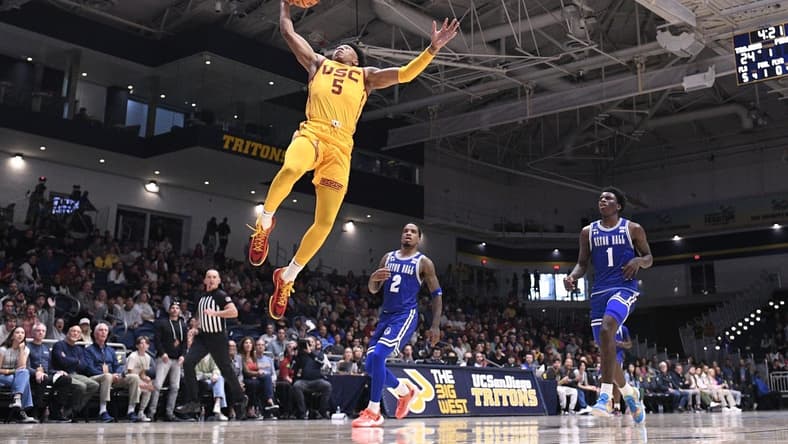 Nov 23, 2023; La Jolla, California, USA; USC Trojans guard Boogie Ellis (5) goes to the basket ahead of Seton Hall Pirates guard Al-Amir Dawes (2) and guard Kadary Richmond (1) during the first half at LionTree Arena. Mandatory Credit: Orlando Ramirez-USA TODAY Sports