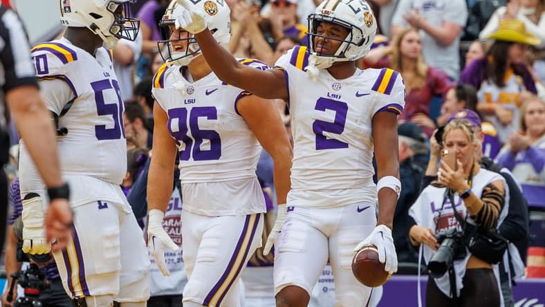 Nov 25, 2023; Baton Rouge, Louisiana, USA; LSU Tigers wide receiver Kyren Lacy (2) points to quarterback Jayden Daniels (5) after scoring a touchdown against the Texas A&M Aggies during the second half at Tiger Stadium. Mandatory Credit: Stephen Lew-USA TODAY Sports