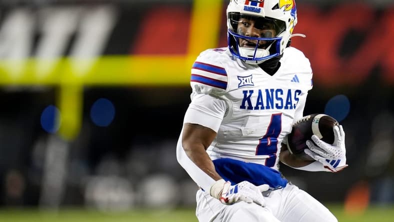 Kansas Jayhawks running back Devin Neal (4) scores a touch down during the NCAA college football game between the Cincinnati Bearcats and Kansas Jayhawks on Saturday, Nov. 25, 2023, at Nippert Stadium in Cincinnati. This is the Bearcats    last game of the season, as well as their Senior Night Saturday.