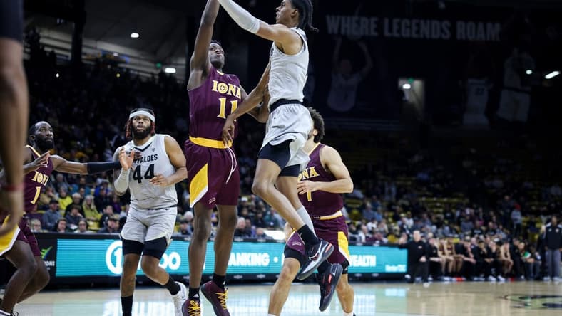 Nov 26, 2023; Boulder, Colorado, USA; Colorado Buffaloes forward Cody Williams (10) goes to the basket against Iona Gaels forward Sultan Adewale (11) during the second half at CU Events Center. Mandatory Credit: Chet Strange-USA TODAY Sports