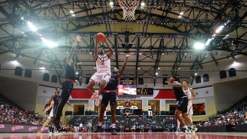 Nov 26, 2023; Kissimmee, FL, USA; Virginia Tech Hokies guard MJ Collins (2) shoots the ball over Florida Atlantic Owls guard Johnell Davis (1) in the second half during the ESPN Events Invitational Championship game at State Farm Field House. Mandatory Credit: Nathan Ray Seebeck-USA TODAY Sports