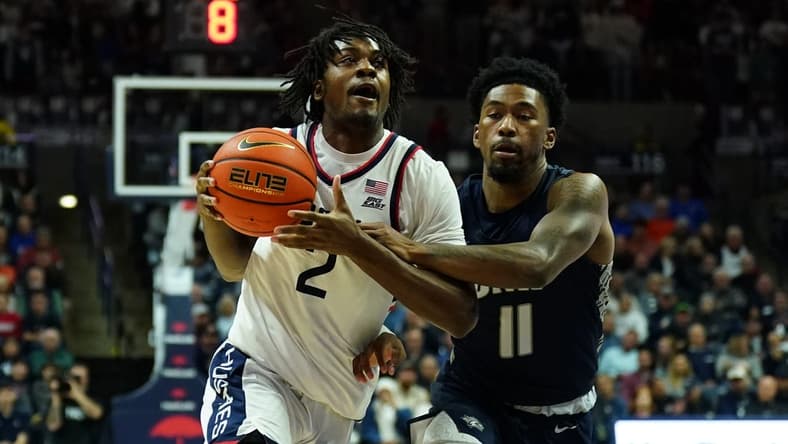 Nov 27, 2023; Storrs, Connecticut, USA; UConn Huskies guard Tristen Newton (2) drives the ball against New Hampshire Wildcats guard Christian Moore (11) in the first half at Harry A. Gampel Pavilion. Mandatory Credit: David Butler II-USA TODAY Sports