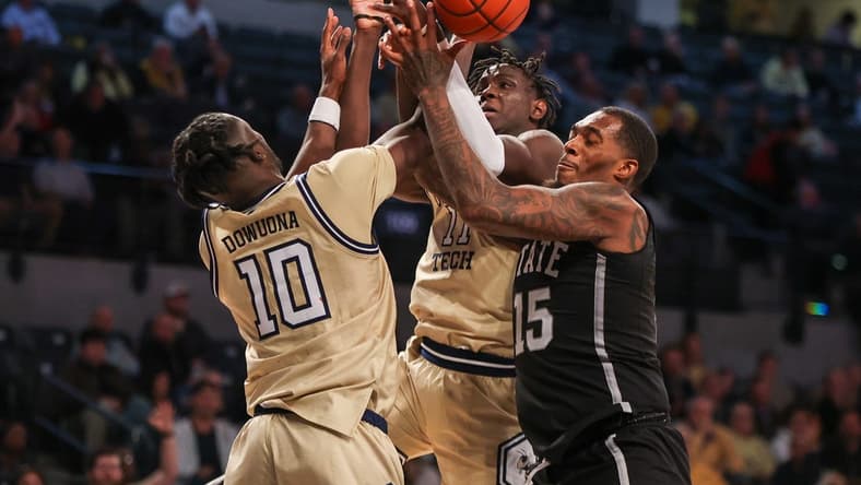 Nov 28, 2023; Atlanta, Georgia, USA; Georgia Tech Yellow Jackets forward Ebenezer Dowuona (10) and forward Baye Ndongo (11) reach for a rebound with Mississippi State Bulldogs forward Jimmy Bell Jr. (15) in the second half at McCamish Pavilion. Mandatory Credit: Brett Davis-USA TODAY Sports