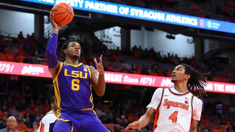 Nov 28, 2023; Syracuse, New York, USA; LSU Tigers guard Jordan Wright (6) shoots the ball as Syracuse Orange forward Chris Bell (4) defends during the first half at the JMA Wireless Dome. Mandatory Credit: Rich Barnes-USA TODAY Sports