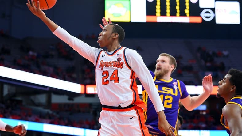 Nov 28, 2023; Syracuse, New York, USA; Syracuse Orange guard Quadir Copeland (24) shoots the ball in front of LSU Tigers forward Hunter Dean (12) during the second half at the JMA Wireless Dome. Mandatory Credit: Rich Barnes-USA TODAY Sports