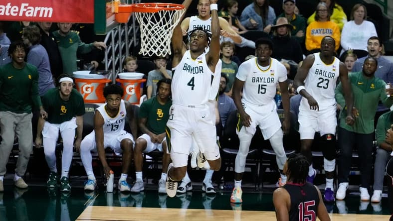 Nov 28, 2023; Waco, Texas, USA;  Baylor Bears guard Ja'Kobe Walter (4) dunks against the Nicholls State Colonels during the second half at Ferrell Center. Mandatory Credit: Chris Jones-USA TODAY Sports