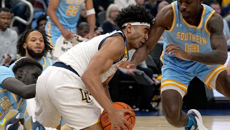 Nov 28, 2023; Milwaukee, Wisconsin, USA; Marquette Golden Eagles guard Stevie Mitchell (4) beats Southern Jaguars forward Delang Muon (35) and guard Dre'Shawn Allen (13) to a loose ball during the first half at Fiserv Forum. Mandatory Credit: Mark Hoffman-USA TODAY Sports