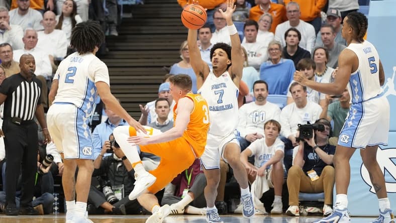 Nov 29, 2023; Chapel Hill, North Carolina, USA; Tennessee Volunteers guard Dalton Knecht (3) trips as North Carolina Tar Heels guard Seth Trimble (7) defends in the second half at Dean E. Smith Center. Mandatory Credit: Bob Donnan-USA TODAY Sports
