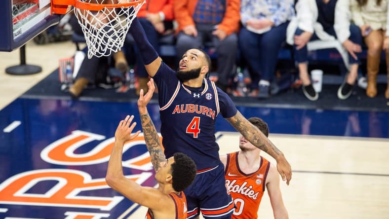 Auburn Tigers player Johni Broome (4) attempts to tip the ball as Auburn Tigers take on Virginia Tech Hokies at Neville Arena in Auburn, Ala., on Wednesday, Nov. 29, 2023. Auburn Tigers defeated Virginia Tech Hokies 74-57.