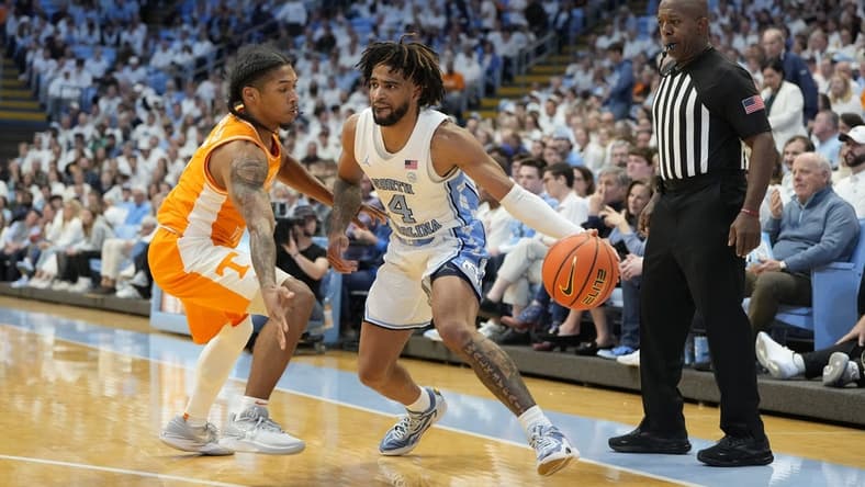 Nov 29, 2023; Chapel Hill, North Carolina, USA; North Carolina Tar Heels guard RJ Davis (4) with the ball as Tennessee Volunteers guard Zakai Zeigler (5) defends in the second half at Dean E. Smith Center. Mandatory Credit: Bob Donnan-USA TODAY Sports