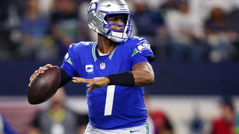 Nov 30, 2023; Arlington, Texas, USA; Seattle Seahawks quarterback Geno Smith (7) looks to pass against the Dallas Cowboys during the first half at AT&T Stadium. Mandatory Credit: Tim Heitman-USA TODAY Sports