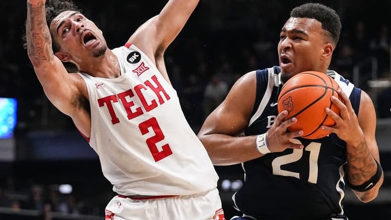 Butler Bulldogs guard Pierre Brooks II (21) runs into Texas Tech Red Raiders guard Pop Isaacs (2) on Thursday, Nov. 30, 2023, during the game at Hinkle Fieldhouse in Indianapolis. The Butler Bulldogs defeated the Texas Tech Red Raiders in overtime, 103-95.