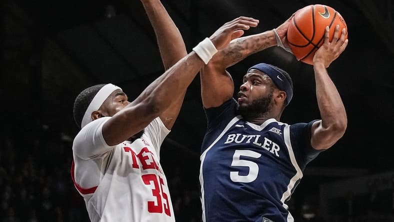 Butler Bulldogs guard Posh Alexander (5) attempts to score against Texas Tech Red Raiders forward Devan Cambridge (35) on Thursday, Nov. 30, 2023, during the game at Hinkle Fieldhouse in Indianapolis. The Butler Bulldogs defeated the Texas Tech Red Raiders in overtime, 103-95.