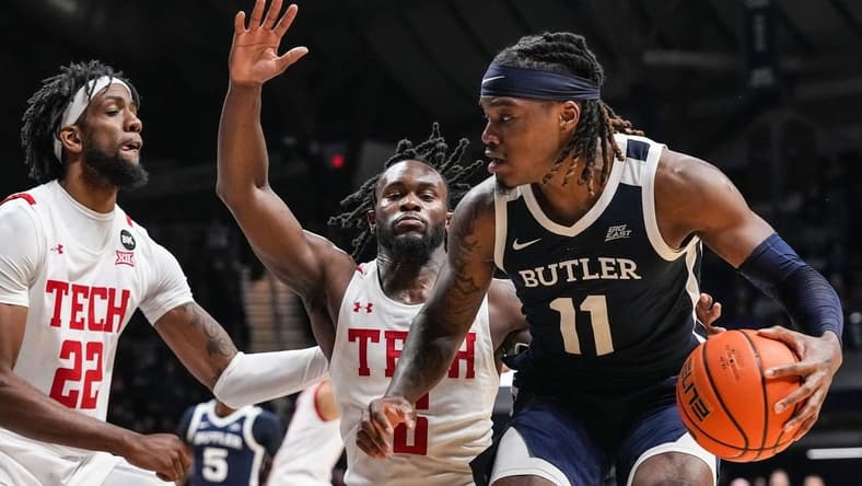 Butler Bulldogs guard Jahmyl Telfort (11) rushes up the court against Texas Tech Red Raiders guard Joe Toussaint (6) and Texas Tech Red Raiders forward Warren Washington (22) on Thursday, Nov. 30, 2023, during the game at Hinkle Fieldhouse in Indianapolis. The Butler Bulldogs defeated the Texas Tech Red Raiders in overtime, 103-95.