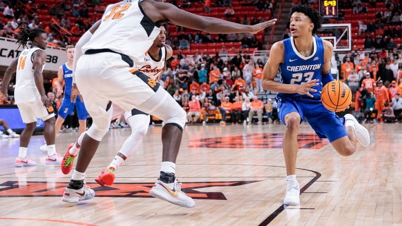 Nov 30, 2023; Stillwater, Oklahoma, USA; Creighton Bluejays guard Trey Alexander (23) drives to the basket around Oklahoma State Cowboys center Mike Marsh (32) during the second half at Gallagher-Iba Arena. Mandatory Credit: William Purnell-USA TODAY Sports