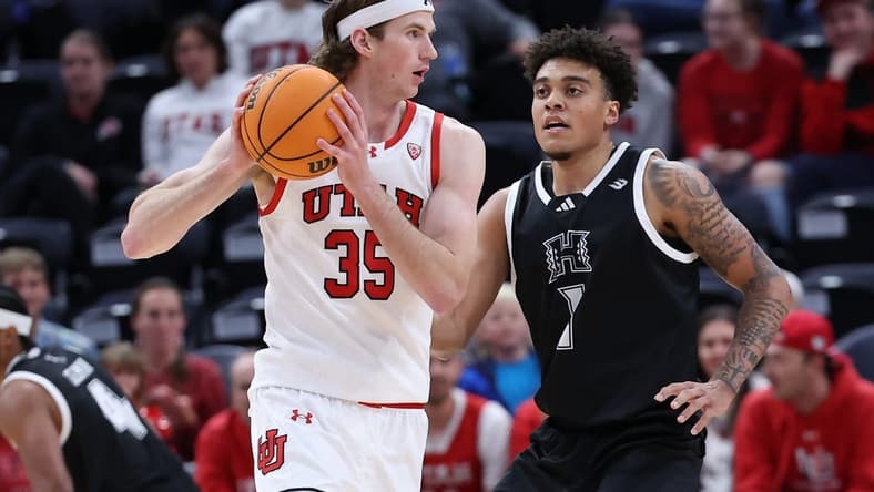 Nov 30, 2023; Salt Lake City, Utah, USA; Utah Utes center Branden Carlson (35) looks to pass the ball against Hawaii Warriors forward Justin McKoy (1) during the first half at Delta Center. Mandatory Credit: Rob Gray-USA TODAY Sports
